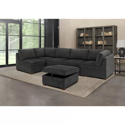 Front angled view of the Thomasville Tisdale dark grey fabric corner chair featuring tufted seat cushions and solid block wood legs on a modern light oak floor.