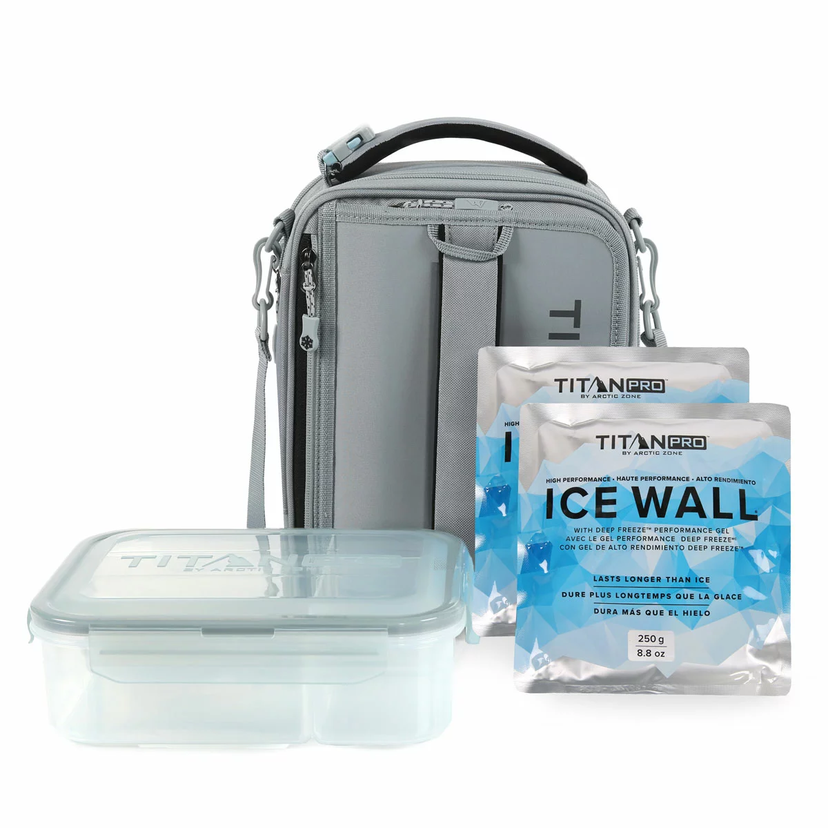 Three-quarter view of the expandable blue Titan Pro Lunch Box in its expanded state on a stone kitchen island, with the bento box and ice walls placed neatly beside it.
