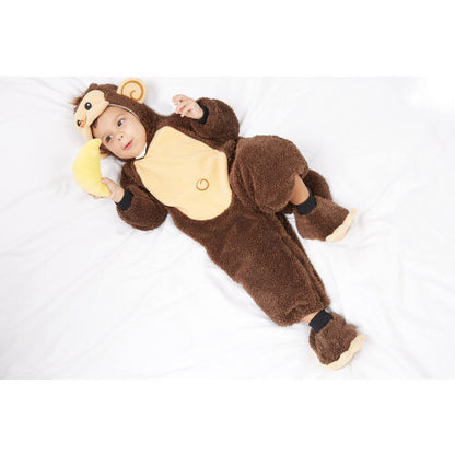 Full-length front view of an 18-24 month toddler wearing a brown plush monkey costume suit with hood, matching booties, holding a yellow plush toy banana.