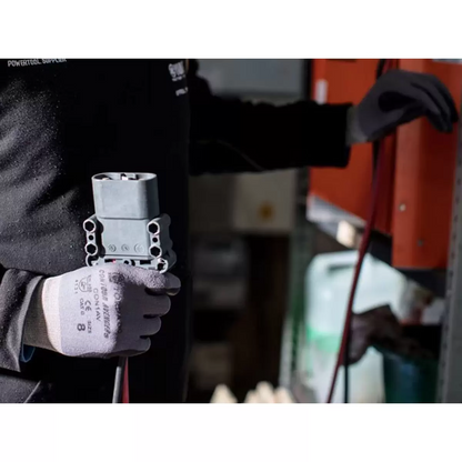 Black and grey Tornado Contour Avenger seamless nylon work gloves with bi-polymer palm coating on a technician workbench.