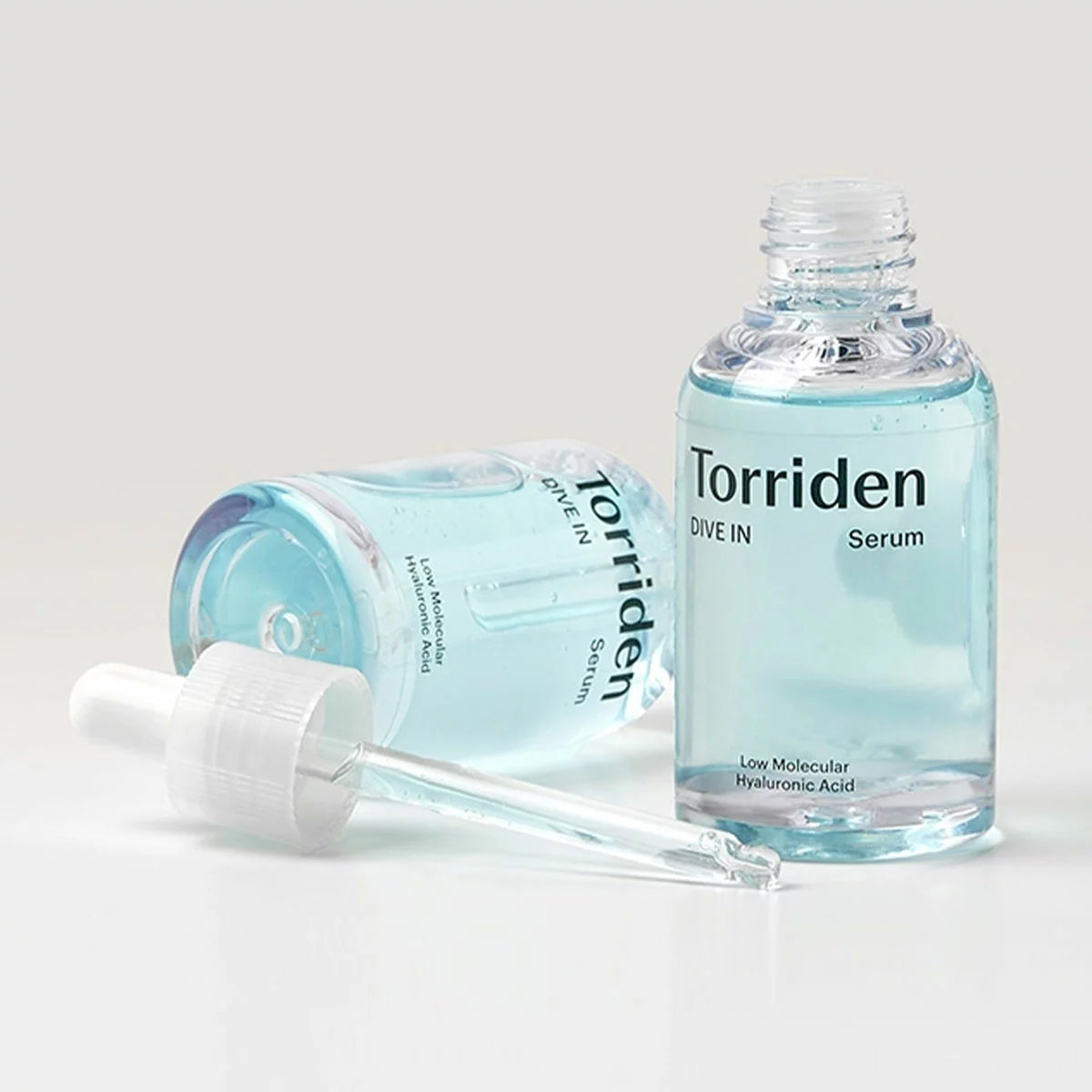 The Torriden Dive-in Serum collection, featuring two 50ml bottles and one 20ml travel bottle, displayed against a clean, professional background
