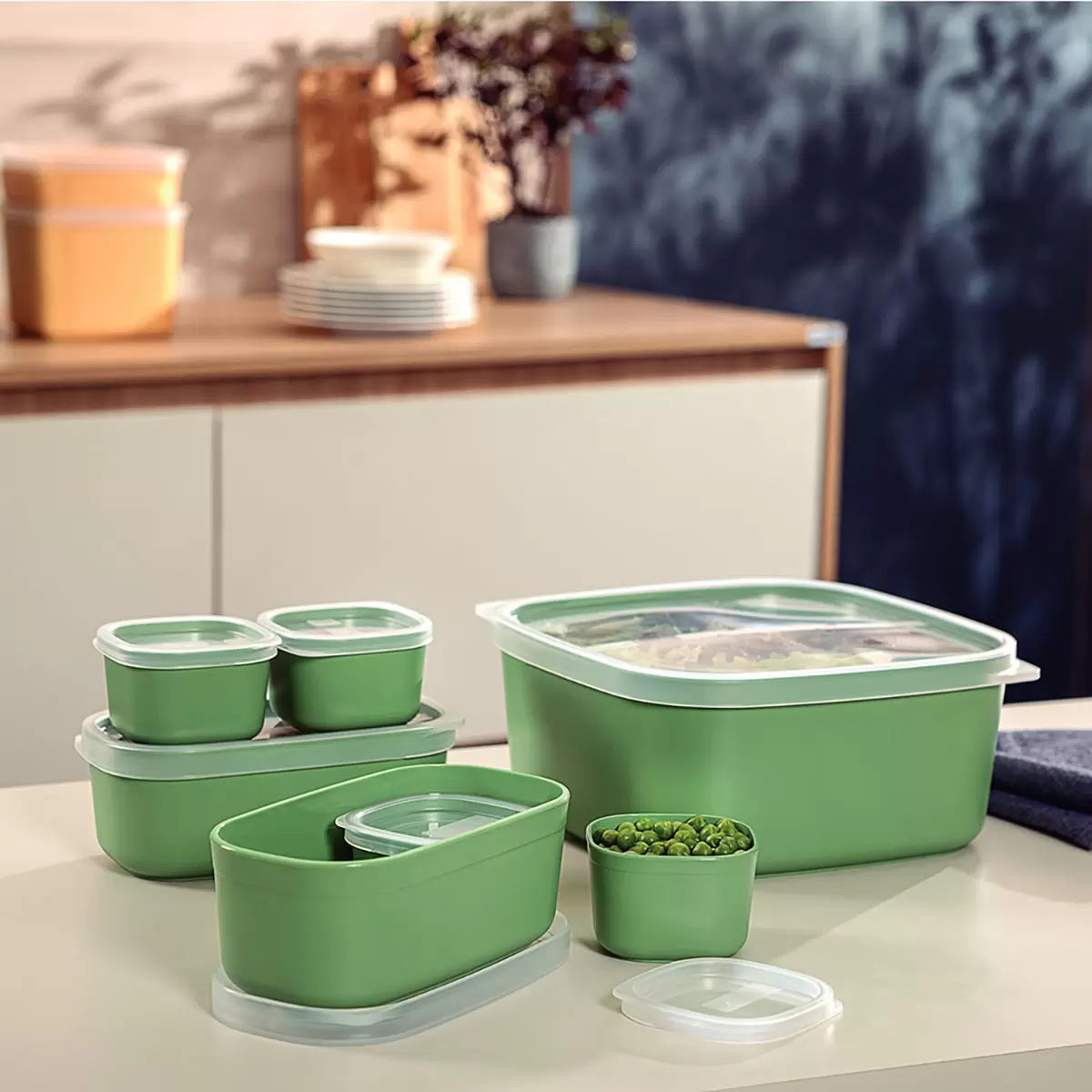 Tramontina 7-piece food storage set in cream and green, neatly organized on a kitchen counter.