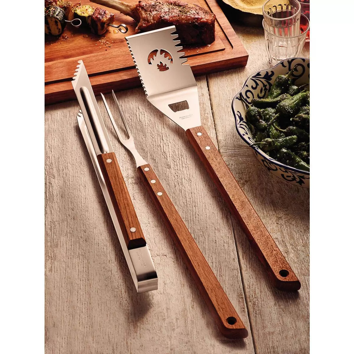 A 3-piece Tramontina BBQ tool set featuring stainless steel utensils with ergonomic, heat-resistant hardwood handles on a clean background.