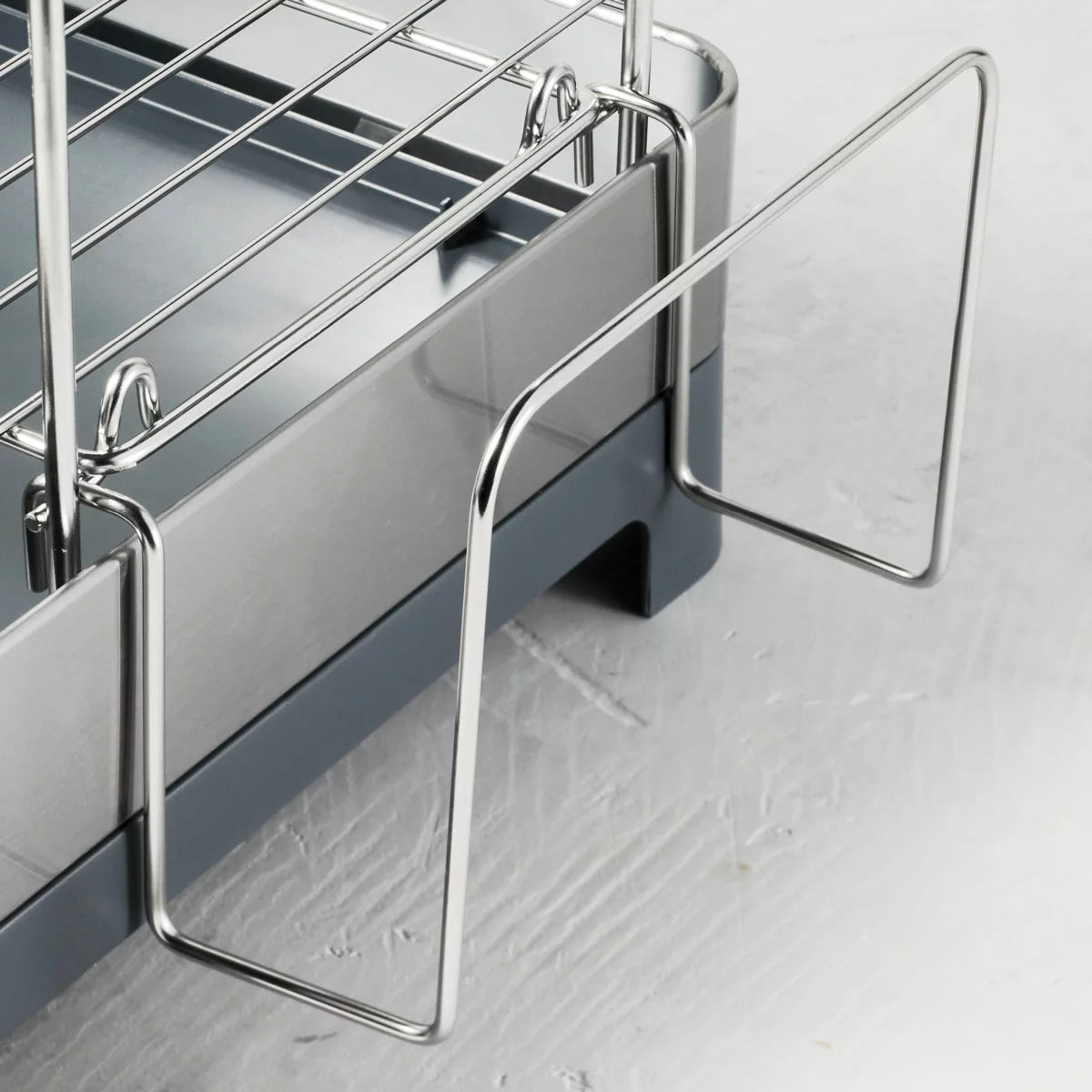 Tramontina 2-tier stainless steel dish rack neatly organised on a modern kitchen countertop.