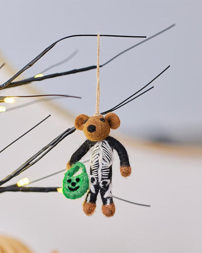 Trick or Treat Skeleton Tree Decoration featuring a bone-white sculpted resin skeleton hanging on a dark autumn branch.
