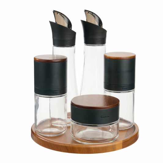 Trudeau 6-piece seasoning station featuring salt and pepper mills, oil bottles, and a rotating acacia base.