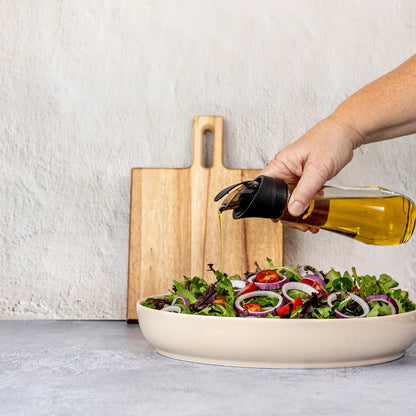Trudeau 6-piece seasoning station featuring salt and pepper mills, oil bottles, and a rotating acacia base.