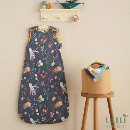 Tutti Bambini white and blue 2.5 Tog bamboo cotton baby sleeping bag displayed flat on a neutral nursery surface.