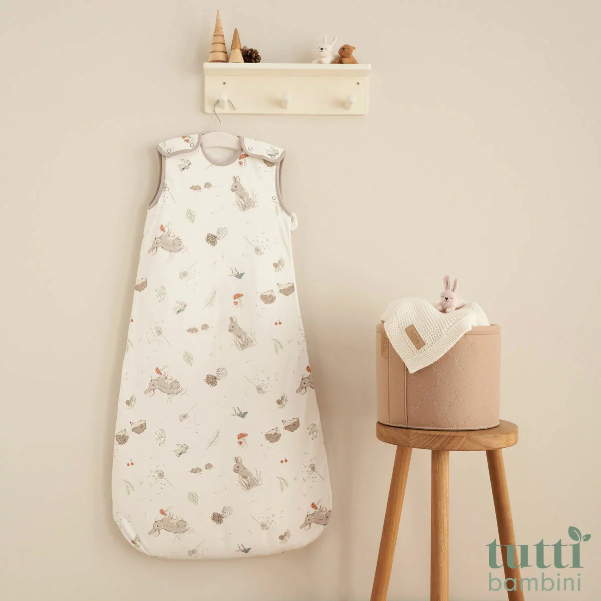 Tutti Bambini white and blue 2.5 Tog bamboo cotton baby sleeping bag displayed flat on a neutral nursery surface.