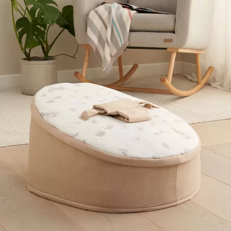 The zip-off top layer being removed from the Tutti Bambini baby beanbag to transition it into a toddler lounge chair.