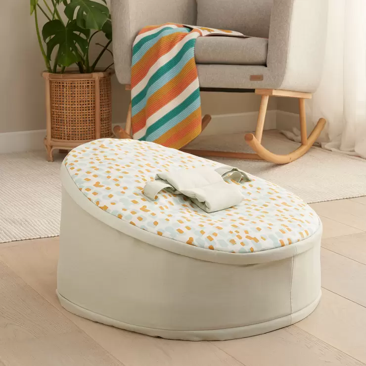 The zip-off top layer being removed from the Tutti Bambini baby beanbag to transition it into a toddler lounge chair.
