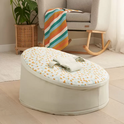 The zip-off top layer being removed from the Tutti Bambini baby beanbag to transition it into a toddler lounge chair.