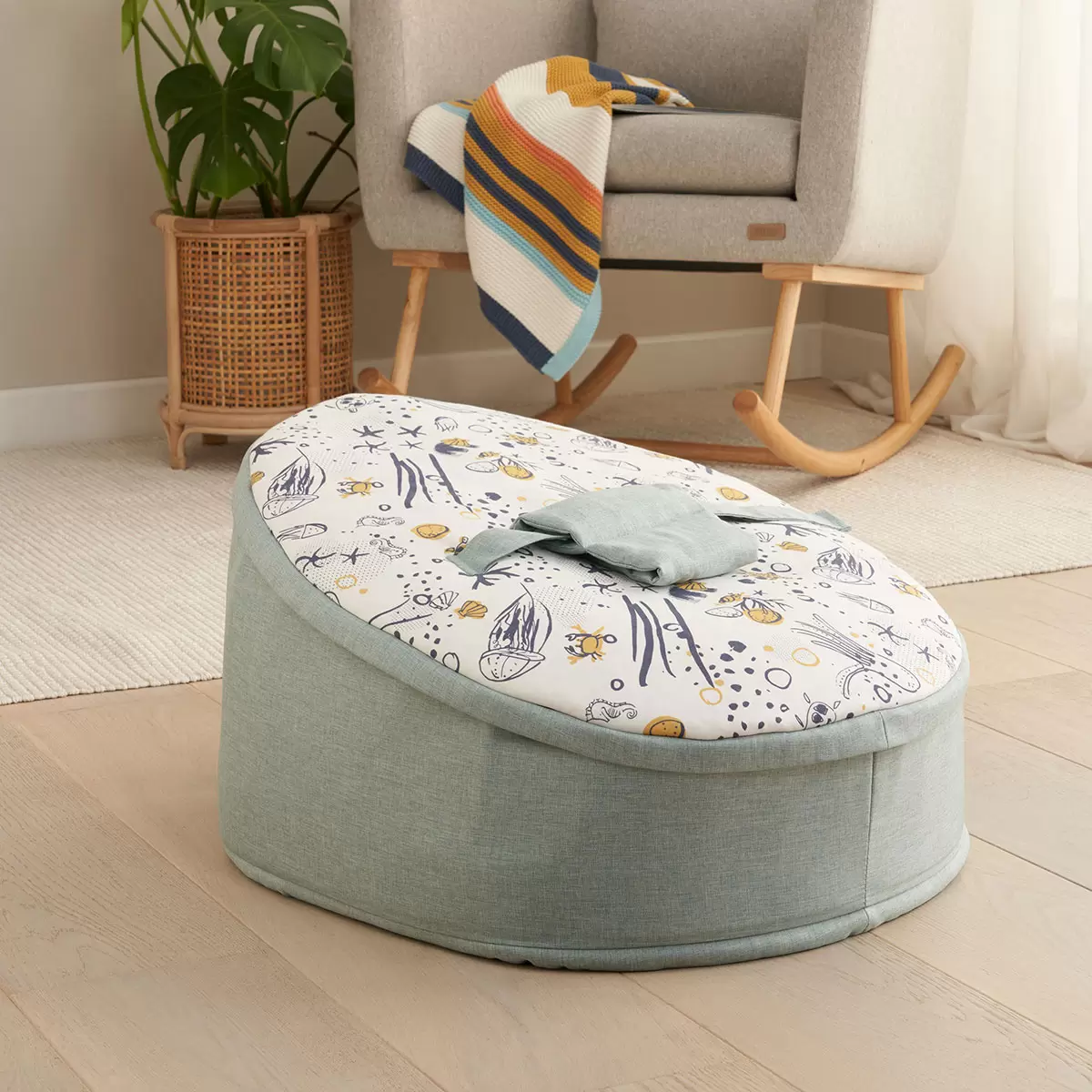 The zip-off top layer being removed from the Tutti Bambini baby beanbag to transition it into a toddler lounge chair.