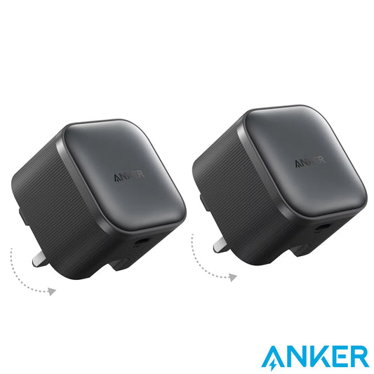Two ultra-compact black Anker Nano 45W chargers showing their foldable metal pins, resting side-by-side on a modern office desk.