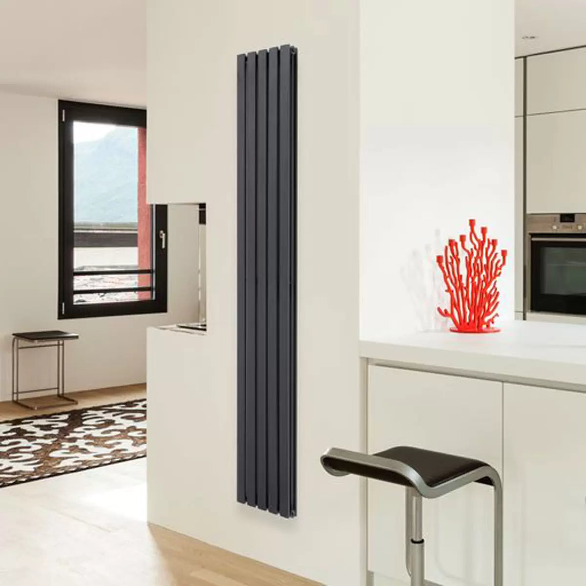 Vertical Ultraheat Linear Radiator in a contemporary living space showing 10 slim powder-coated steel columns mounted flush against a modern wall.