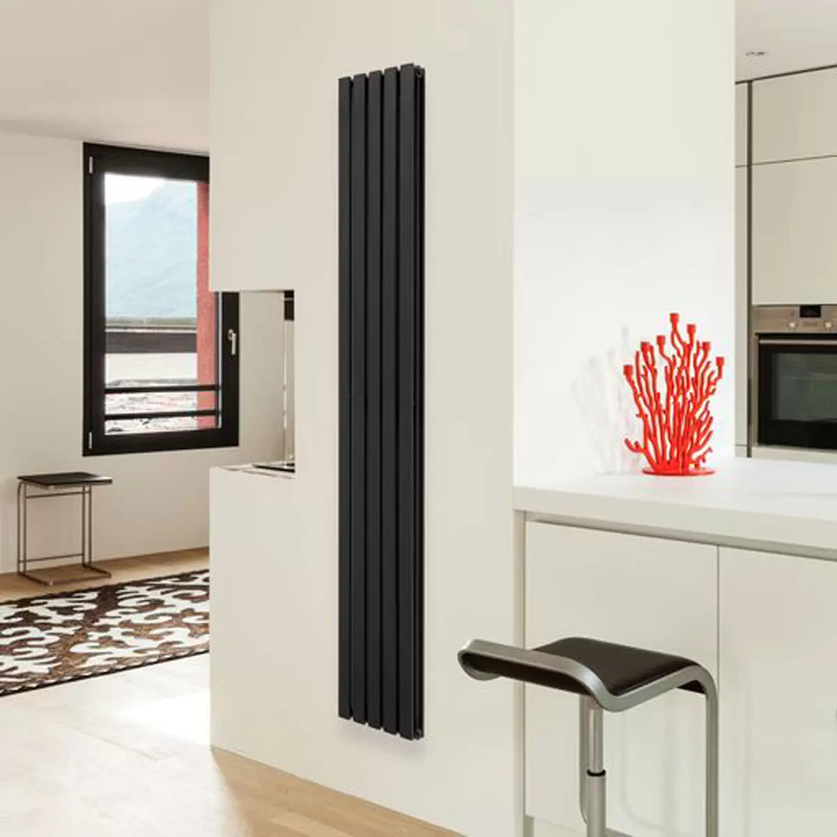 Vertical Ultraheat Linear Radiator in a contemporary living space showing 10 slim powder-coated steel columns mounted flush against a modern wall.