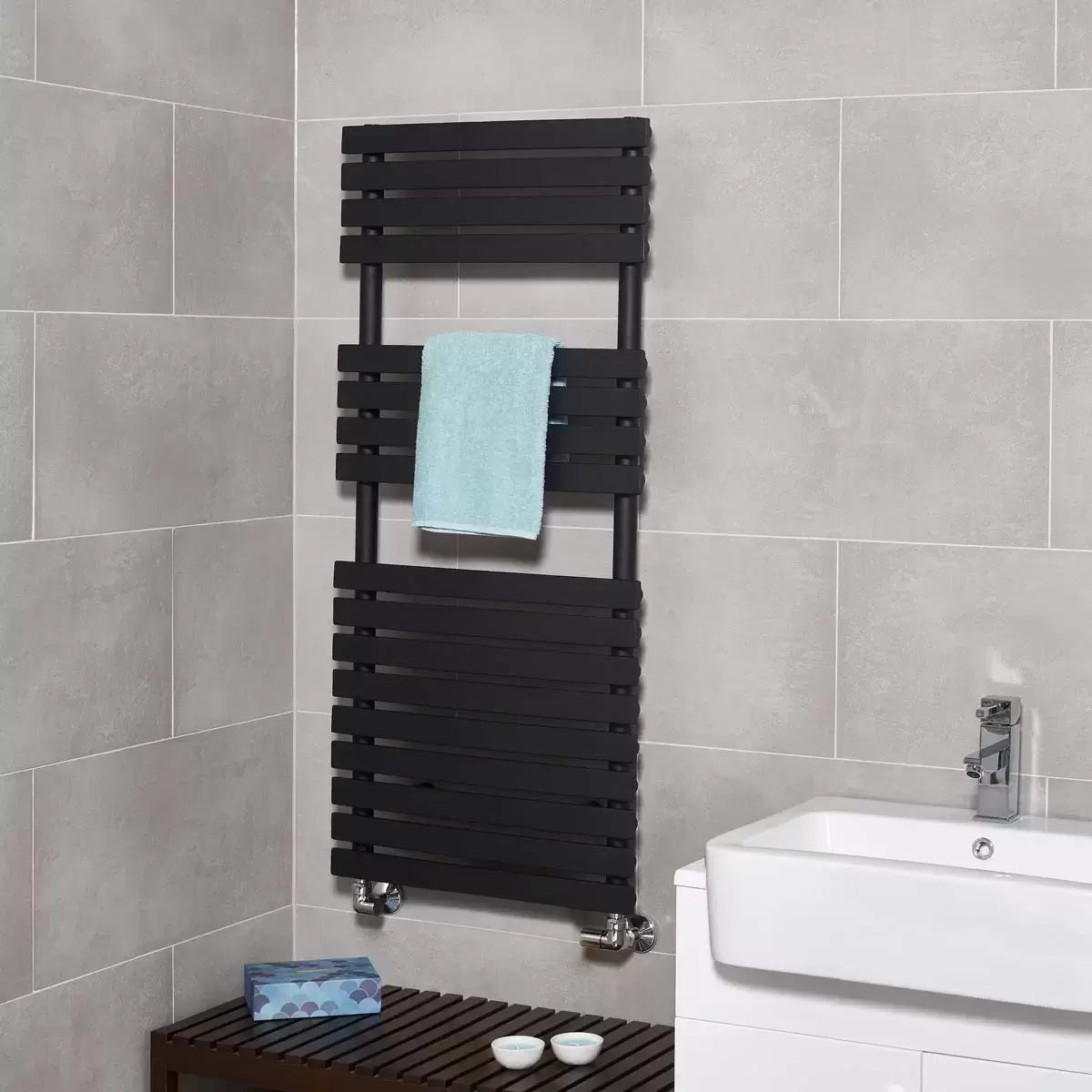 Front angle view of the Ultraheat Poplar Radiator featuring 17 flat horizontal bars in a dark micro grain textured finish mounted against a light tiled bathroom wall.