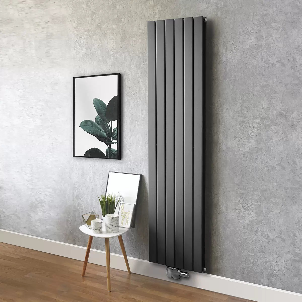 Vertical Ultraheat Tian Slate Grey tubular radiator mounted on a light gray wall in a modern open-plan living room setup.