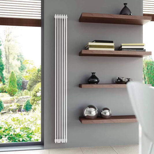 Front view of the vertical Ultraheat Tilbrook white radiator mounted on a smooth kitchen wall showcasing its slim 16-pipe profile.