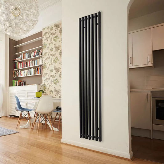Front view of a tall, curved Ultraheat Trojan vertical radiator in a contemporary living room setting.