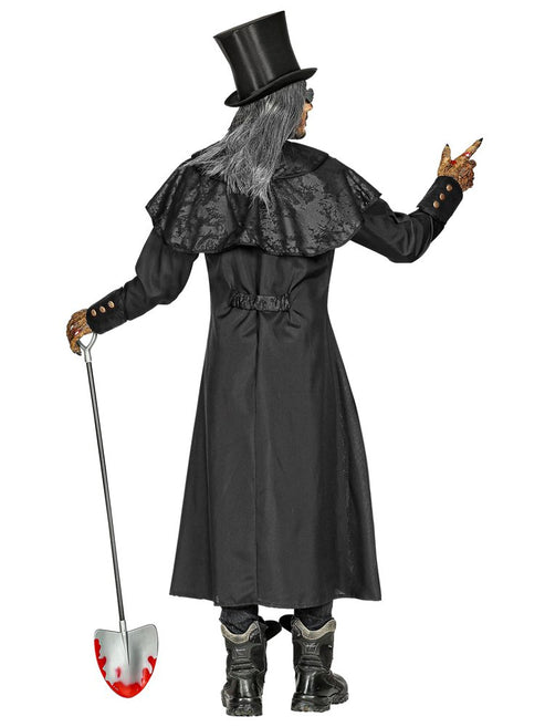 Front view of an adult male wearing a long black undertaker trench coat with wide-brim hat against a dark backdrop.