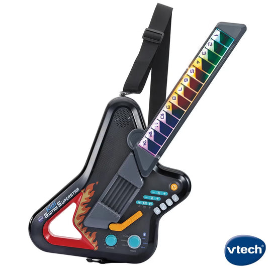 White and blue VTech Kidi Guitar Superstar toy with multi-colored light-up fret buttons and a shoulder strap unfolded against a light gray backdrop.