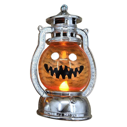 A vintage electroplated plastic electronic Halloween pumpkin lantern glowing softly on a decorative tabletop.