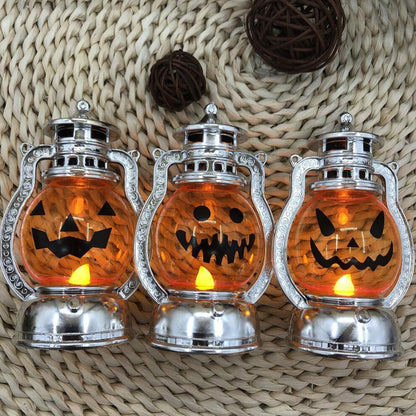 A vintage electroplated plastic electronic Halloween pumpkin lantern glowing softly on a decorative tabletop.