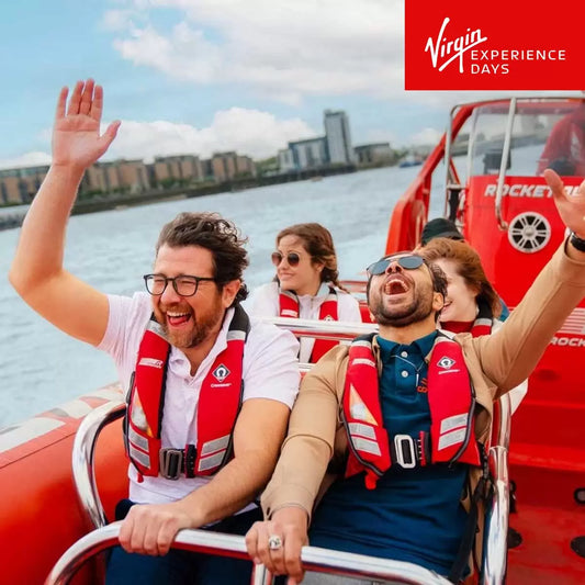 Couple enjoying a high-speed Thames Rocket speed boat ride on the River Thames in London