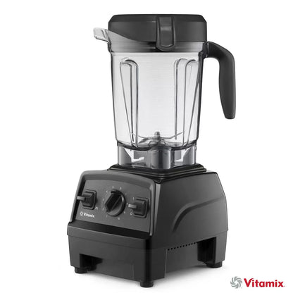 A sleek black Vitamix E320 blender base with its 2L container and tamper sitting on a polished stone kitchen countertop.