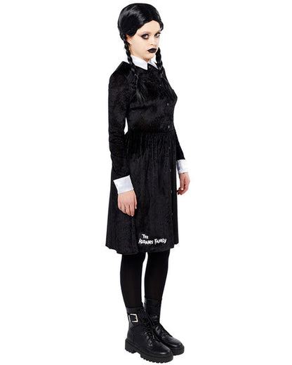 Front view of the black Wednesday Addams adult dress featuring sharp white pointy collar and cuffs on a minimalist studio background.