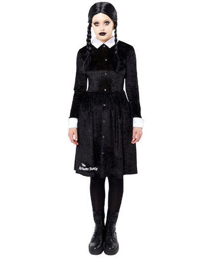 Front view of the black Wednesday Addams adult dress featuring sharp white pointy collar and cuffs on a minimalist studio background.