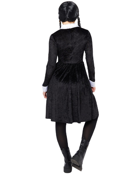 Front view of the black Wednesday Addams adult dress featuring sharp white pointy collar and cuffs on a minimalist studio background.
