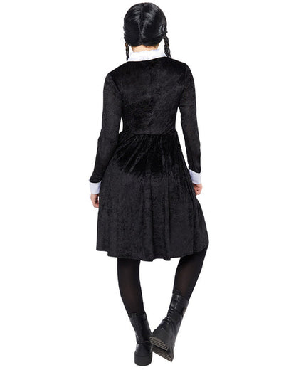 Front view of the black Wednesday Addams adult dress featuring sharp white pointy collar and cuffs on a minimalist studio background.