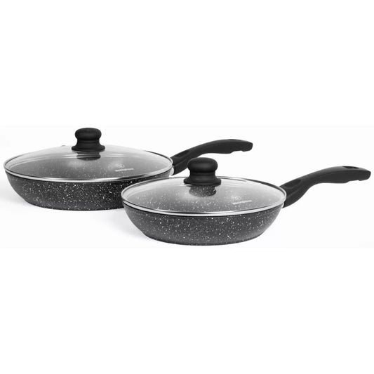 Westinghouse 4-piece black non-stick frying pan set with marble coating, tempered glass lids, and soft-touch silicone handles arranged on a kitchen counter.