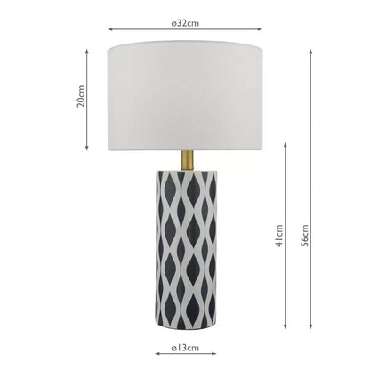 Front view of the Weylin table lamp featuring a glossy blue and white glazed ceramic base under a crisp white faux silk shade, illuminating a modern wooden bedside table.