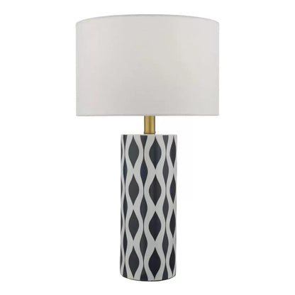Front view of the Weylin table lamp featuring a glossy blue and white glazed ceramic base under a crisp white faux silk shade, illuminating a modern wooden bedside table.