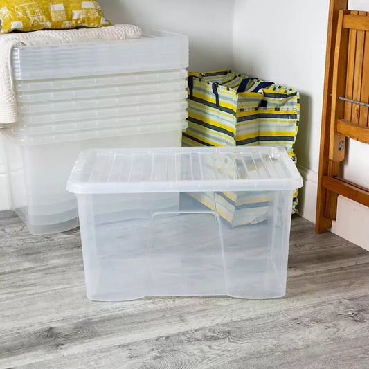 A stack of five transparent Wham 60-litre plastic storage boxes with securely clipped blue handles and lids, arranged neatly against a clean white workshop background.
