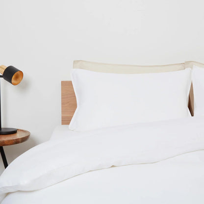 Panda White Bamboo and French Linen Duvet Cover Set on a bed featuring crisp matte texture, Oxford pillowcase edges, and raw bamboo buttons.
