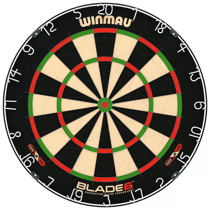 Front-facing studio shot of the round black and green Winmau Blade 6 dartboard displaying its silver razor wiring, shown alongside two sets of brass steel-tip darts and a green oche strip.