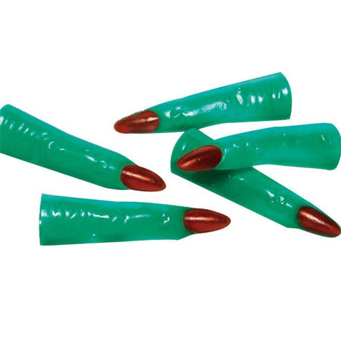 Close-up of green plastic witch fingers with painted red fingernails arranged on a dark Halloween tabletop.