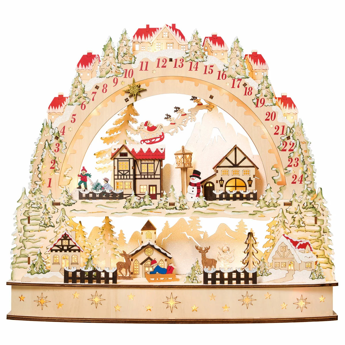 Front view of a laser-cut wooden alpine village advent calendar illuminated by warm internal LED lights on a wooden table.