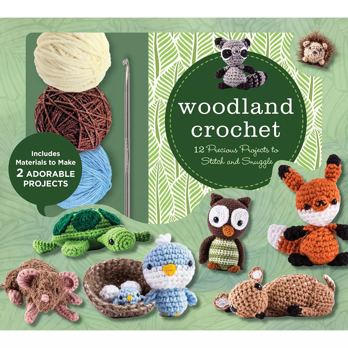 Woodland Crochet Kit box containing a 76-page instruction book, colorful yarn skeins, a metal crochet hook, safety eyes, and completed bluebird and turtle amigurumi figures on a wooden surface.