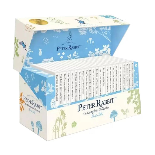 Complete twenty-three book hardback set of Beatrix Potter's Peter Rabbit collection with white dust jackets organized neatly inside a decorated cardboard storage box.