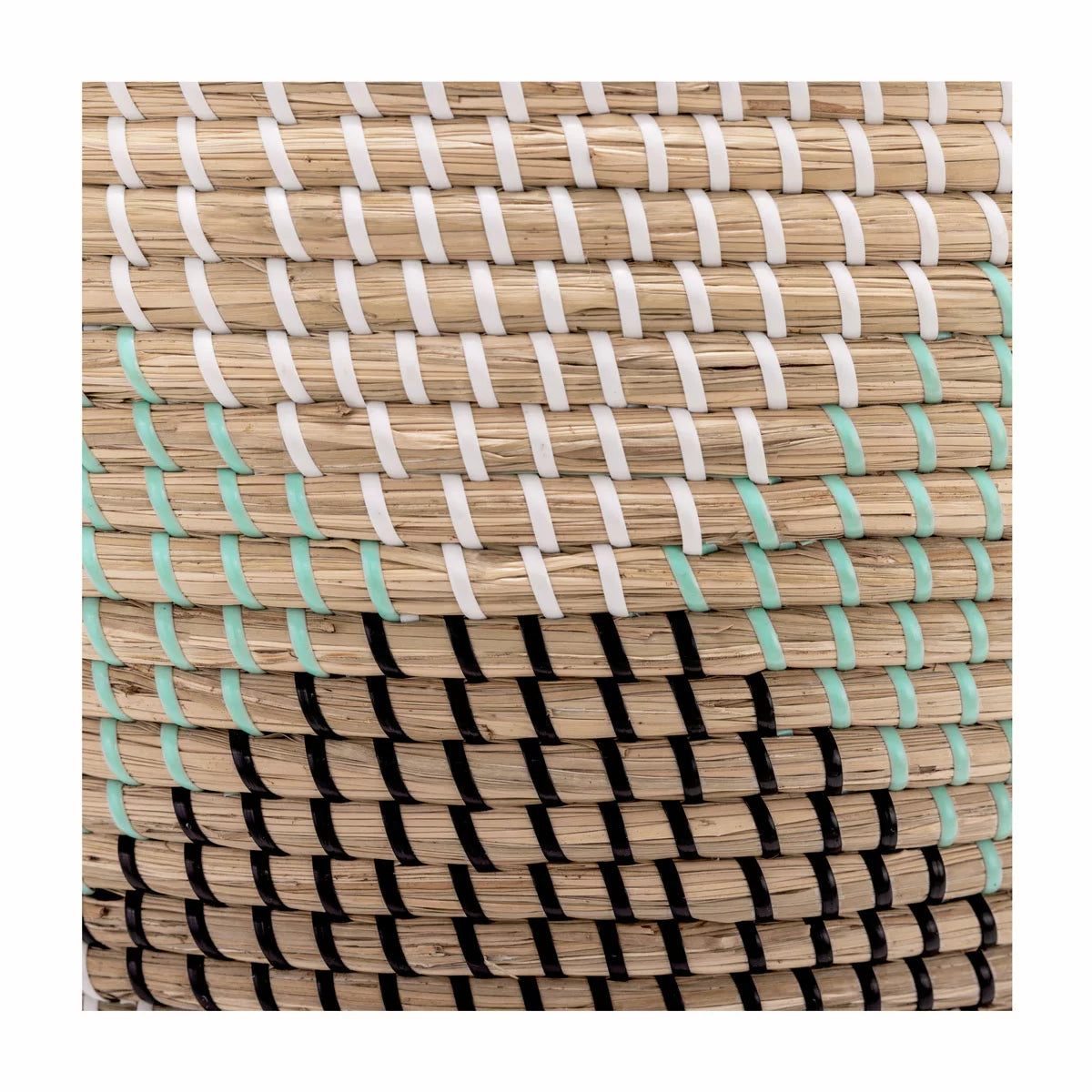 Pair of two nesting handwoven natural brown seagrass storage baskets with integrated handles arranged on a light wood floor in a brightly lit living room.