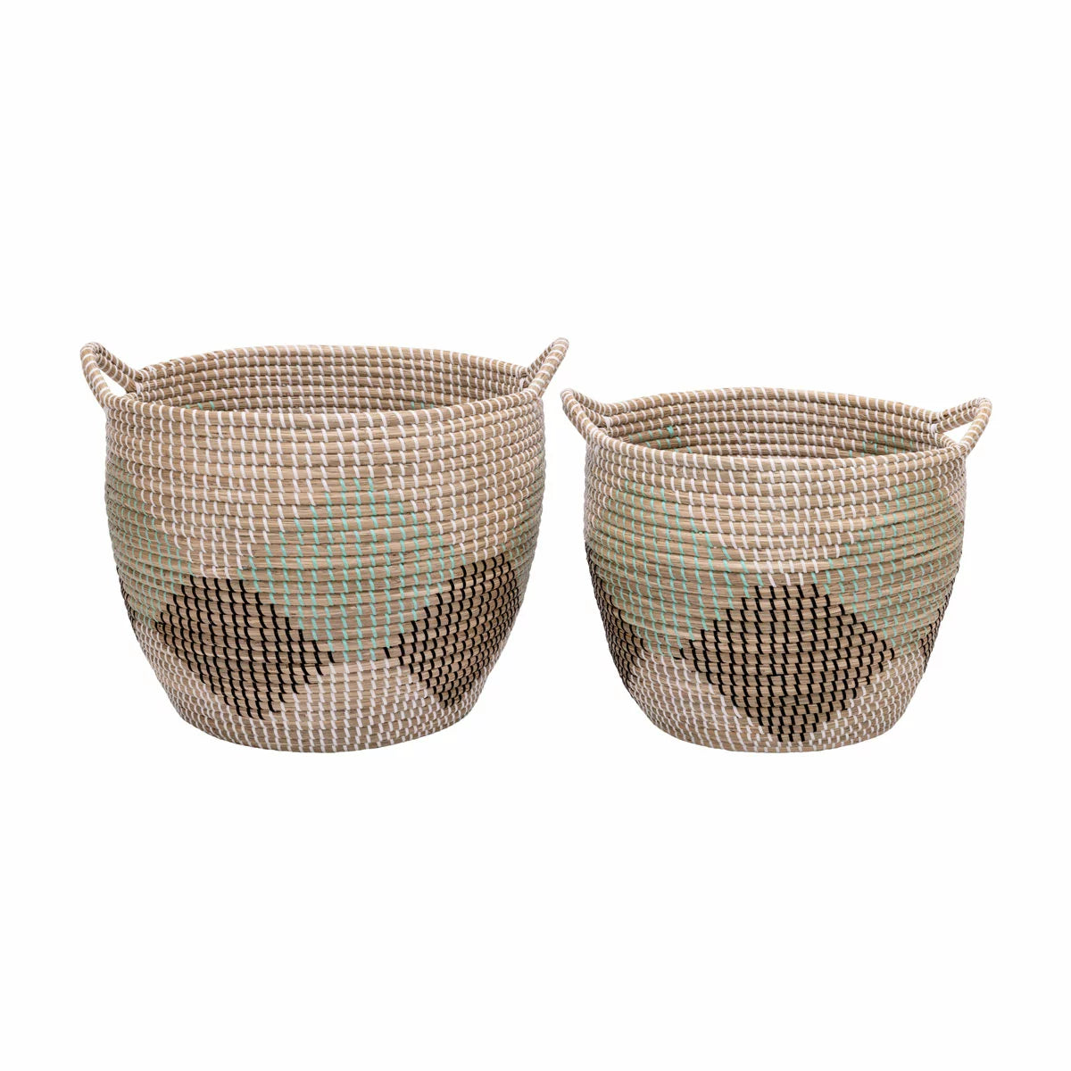 Pair of two nesting handwoven natural brown seagrass storage baskets with integrated handles arranged on a light wood floor in a brightly lit living room.