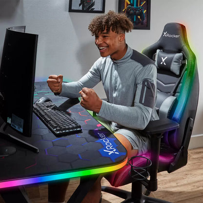 Black PU leather X Rocker Opal RGB gaming chair with colorful Neo Motion LED piping glowing along the backrest in a modern dark gaming room.