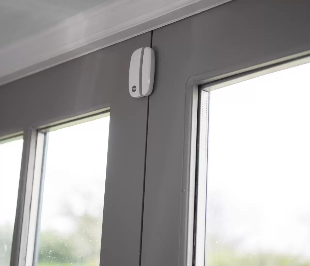 Complete 10-piece Yale IA-320 Sync Smart Home Alarm kit displayed against a white background featuring the yellow siren box, white smart hub, keypad, three door contacts, and four PIR motion sensors.