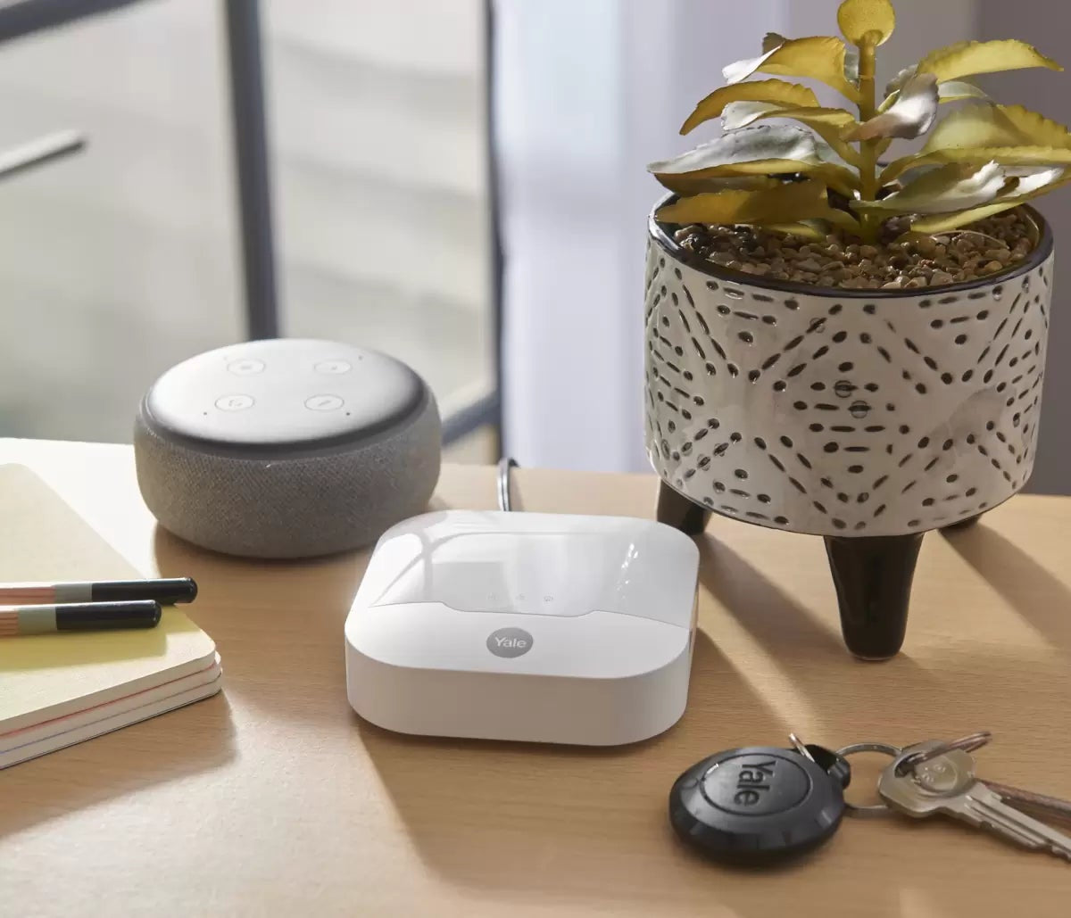 Complete 10-piece Yale IA-320 Sync Smart Home Alarm kit displayed against a white background featuring the yellow siren box, white smart hub, keypad, three door contacts, and four PIR motion sensors.