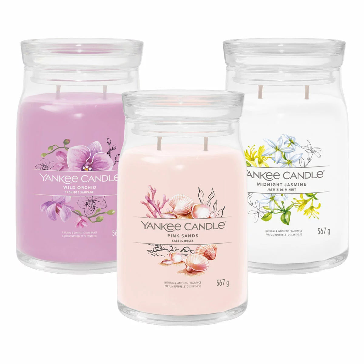 Three large minimalist Yankee Candle jars in ocean breeze, clean cotton, and iced berry lemonade scents arranged on a natural oak table under soft, warm lighting.